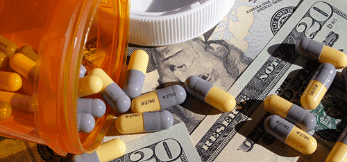 prescription bottle and money on table